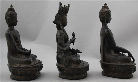 Three A Sino-Tibetan bronze seated figures of Buddhist deities, 20-21cm high